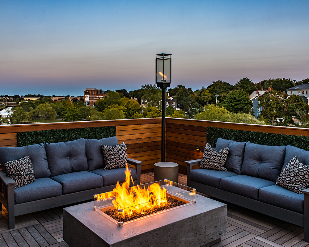 Roof deck with soft seating and fire pit at Halstead Salem Station luxury apartments