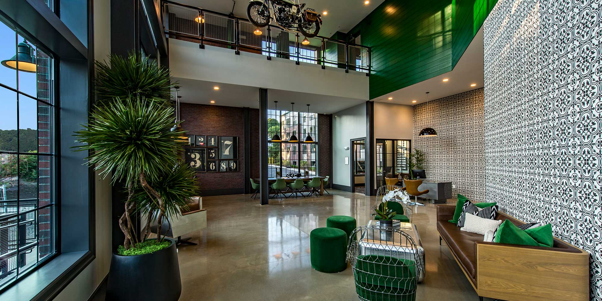 Lobby of Salem Station building with green accents, featuring modern decor and comfortable seating area.