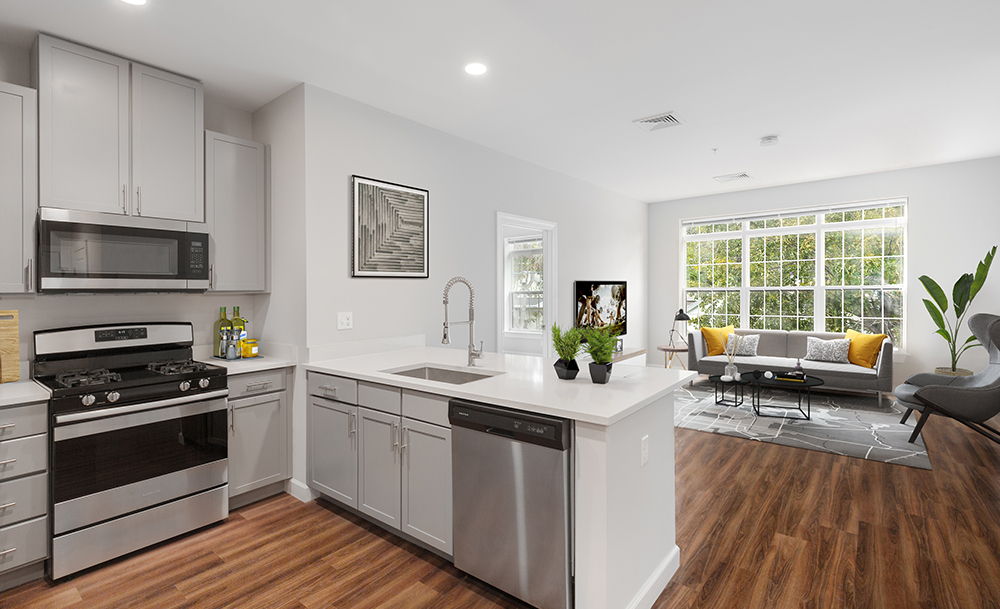 Open kitchen looking out into a bright living room in luxury unit at Halstead Salem Station