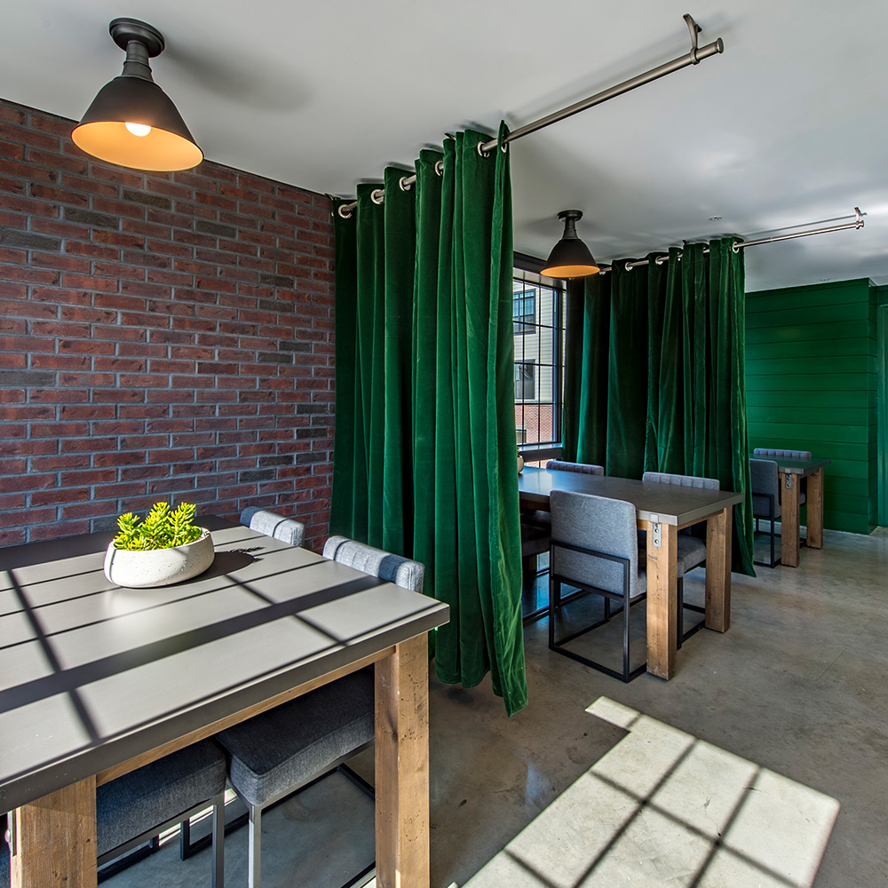 Table seating with curtain dividers in Halstead Salem Station business center