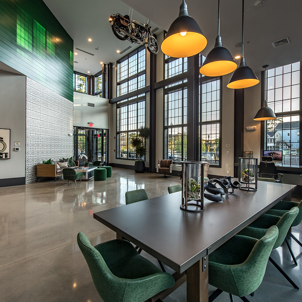 Business center with double height windows at Halstead Salem Station apartments
