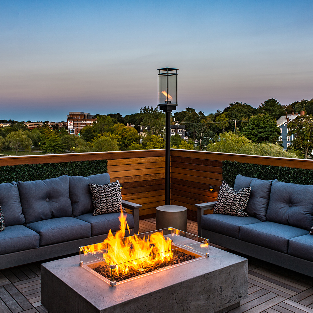 Roof deck with soft seating and fire pit at Halstead Salem Station luxury apartments