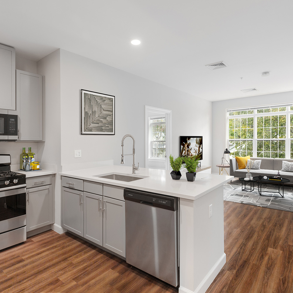 Open kitchen looking out into a bright living room in luxury unit at Halstead Salem Station