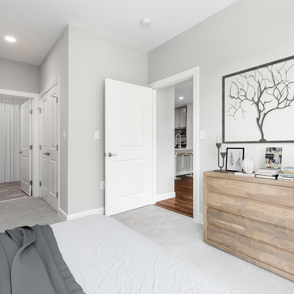 Spacious bedroom off looking into new kitchen in luxury apartment complex, Halstead Salem Station